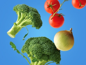 Fresh broccoli, tomatoes on the vine and an onion.