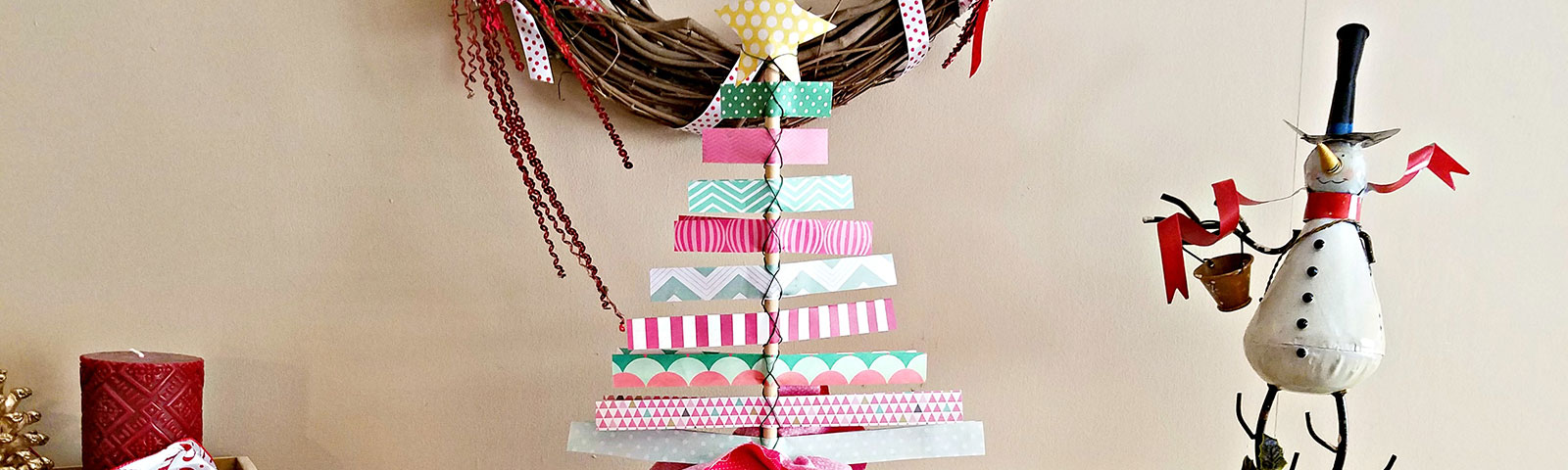 Scrapbook paper made into a Christmas tree standing on a table