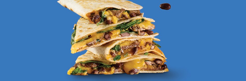 Quesadillas with shredded cheddar cheese, steak, black beans and spinach